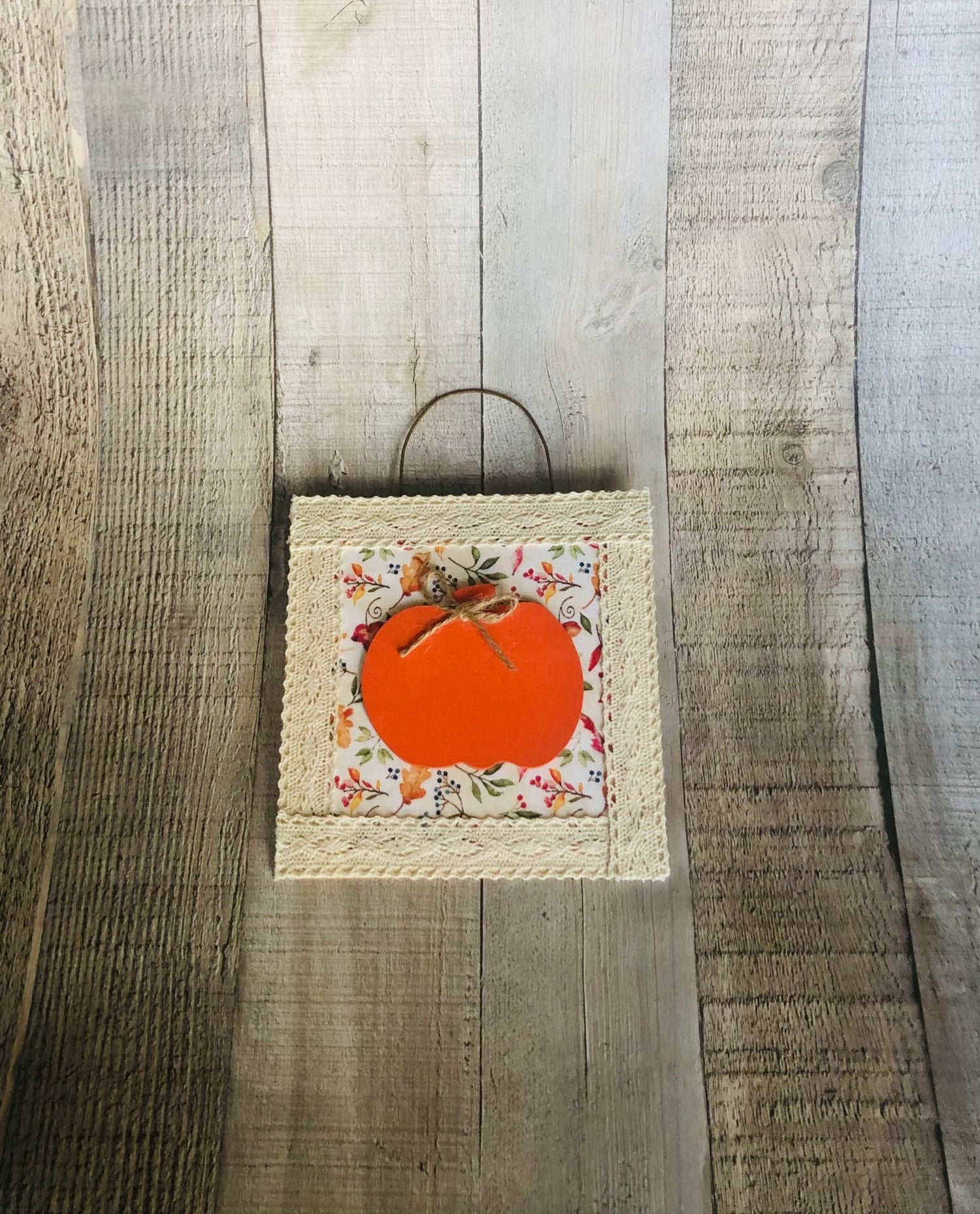 finished pumpkin hanging craft from seniorlycreations.com. Simple crafts for seniors.